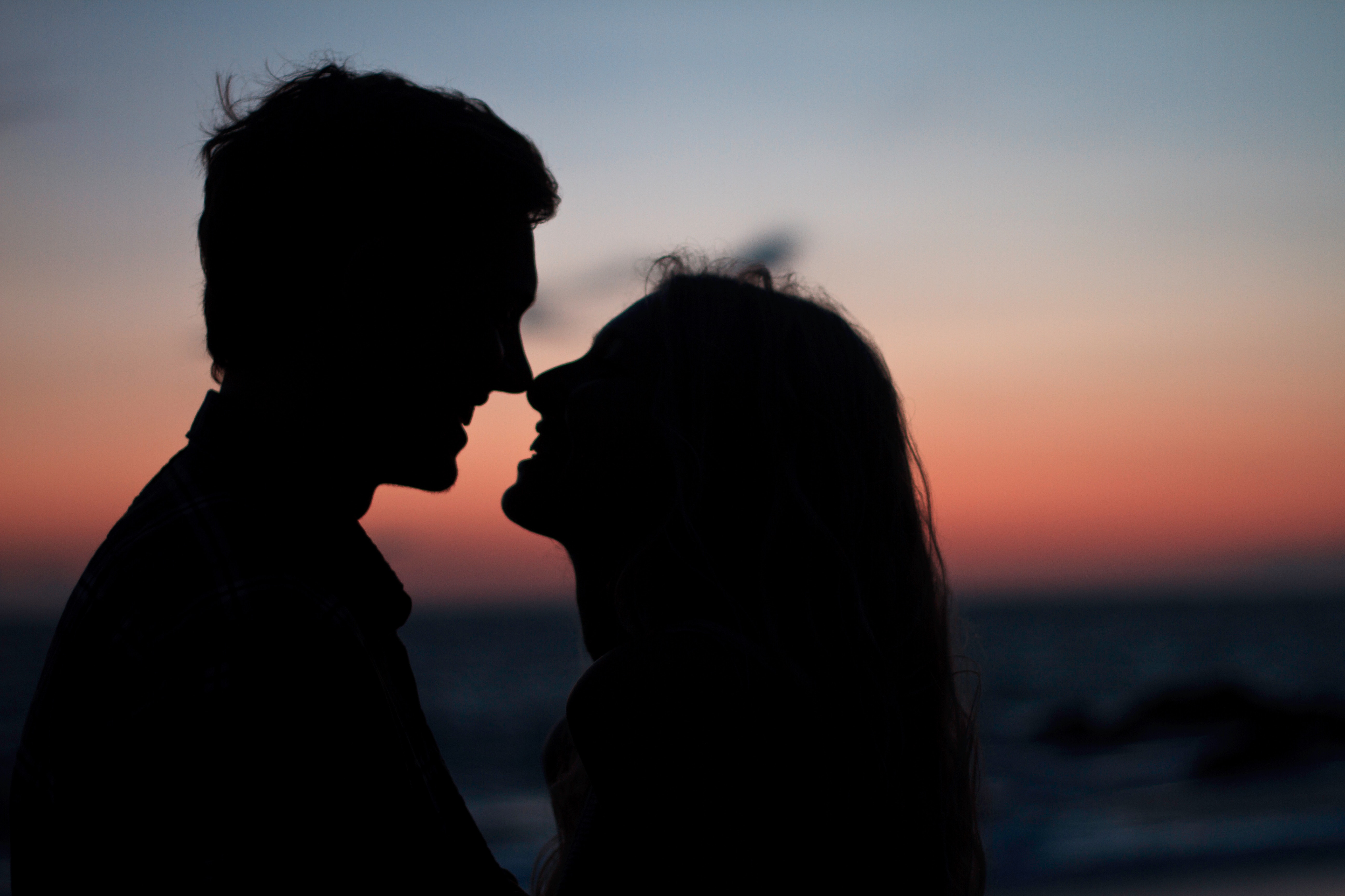 Couple about to kiss on a beach